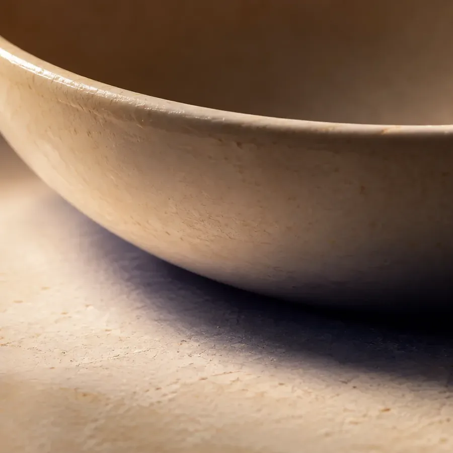 A crescent of shadow under the rim of a bowl