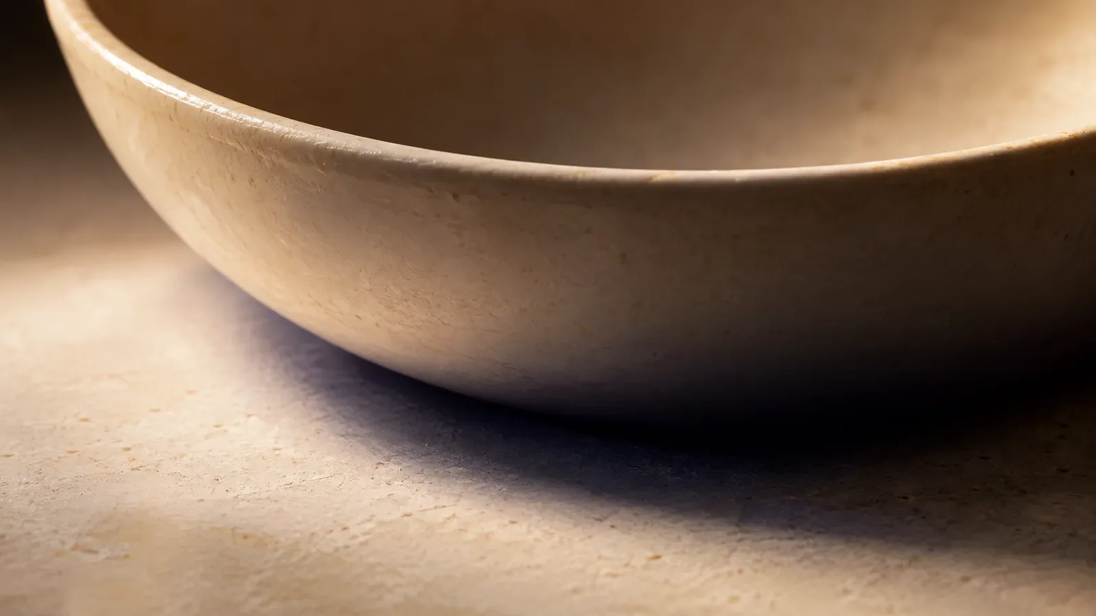 A crescent of shadow under the rim of a bowl